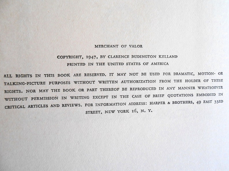 May include: A close-up of a printed page from the book "Merchant of Valor." The text includes copyright information from 1947 by Clarence Budington Kelland, printed in the United States of America. The text also includes a statement of reserved rights.