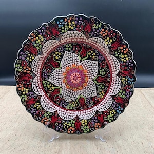 Turkish 180 Degrees decorative ceramic plates. Black background with intricate floral and dot pattern. 10" round.