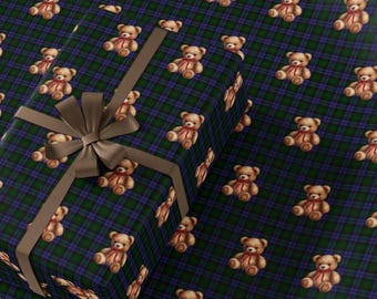 May include: A wrapped gift box with a brown ribbon and bow, set against a background of matching wrapping paper. The paper features a repeating pattern of teddy bears with red bows on a blue and green plaid background.