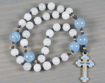 Petite Anglican rosary in milky white quartz and sky blue jade with an light blue enameled gold-plated cross on hand-knotted cord