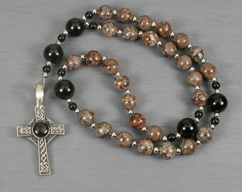 Anglican rosary in brown snowflake jasper and obsidian with an antiqued pewter Celtic cross with a black resin inset