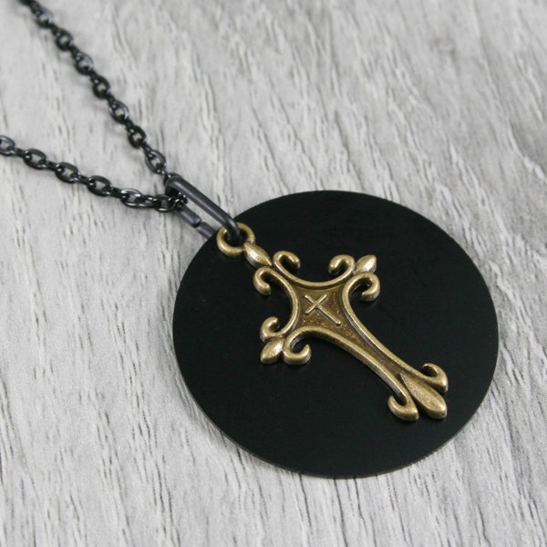 Bronze cross pendant with a black anodized aluminum background on a black cable chain necklace