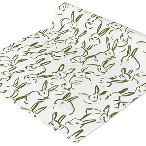 May include: A roll of white wrapping paper with a repeating pattern of green bunny silhouettes.