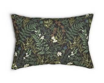 May include: A black pillow with a floral pattern featuring green ferns, white flowers, and brown pine cones.