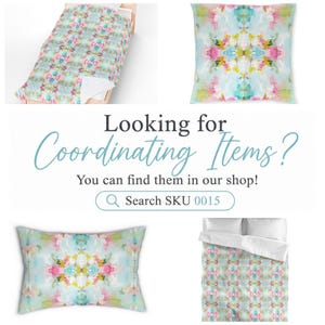 May include: A bedding set and decorative pillows featuring a symmetrical abstract watercolor pattern in shades of light blue, pink, yellow, and green. The image includes text that reads: Looking for Coordinating Items? You can find them in our shop! Search SKU 0015.