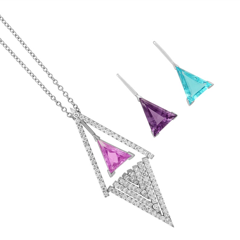 May include: A silver necklace and earring set featuring geometric designs. The necklace has a large, open triangle shape with a pink gemstone and is encrusted with small, clear stones. The earrings are triangular, with purple and turquoise gemstones.
