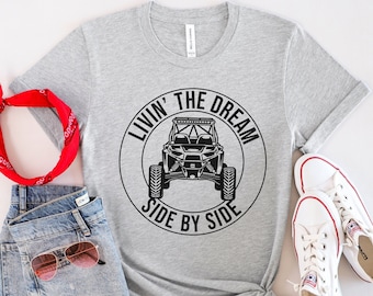 May include: Gray t-shirt with a black circle graphic that says "Livin' The Dream Side By Side" with a black and white illustration of a side-by-side off-road vehicle inside the circle.