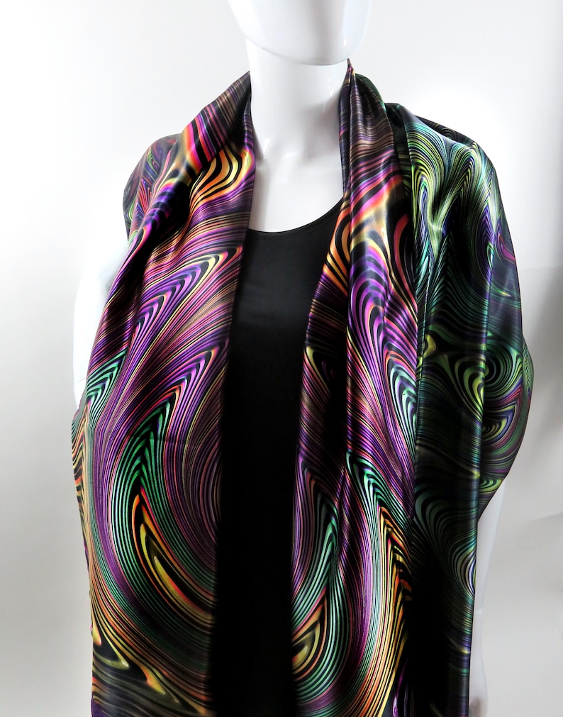 May include: A black satin scarf with a swirling pattern of green, purple, yellow, and orange.