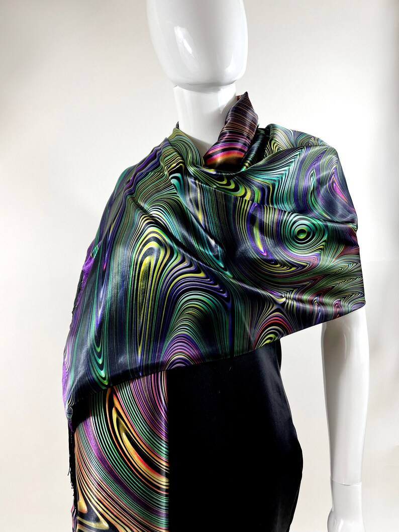 May include: A black satin scarf with a colourful abstract swirl pattern in shades of green, purple, yellow, and orange.