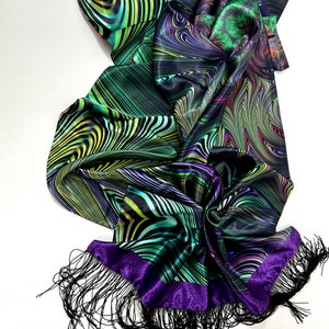May include: A black silk scarf with a green, purple and yellow abstract pattern. The scarf has a purple trim and black fringe.