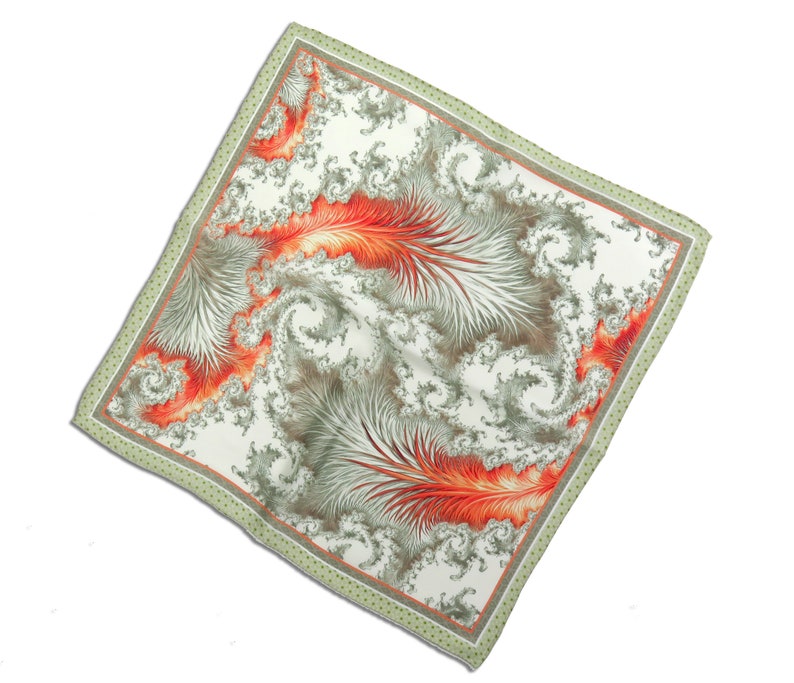 May include: Square scarf with a white background and a swirling, abstract design in shades of orange, gray, and green. The scarf has a green border with small, evenly spaced dots.