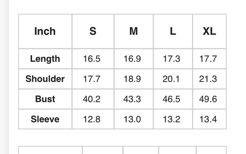 May include: A white chart with black text detailing garment measurements in inches. The chart includes sizes S, M, L, and XL, with measurements for length, shoulder, bust, and sleeve.