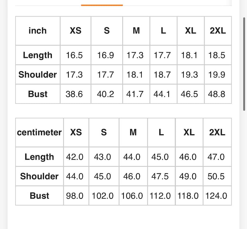 May include: A size chart table with black text on a white background. The table displays garment measurements in inches and centimeters for sizes XS, S, M, L, XL, and 2XL, specifically listing length, shoulder width, and bust measurements for each size.