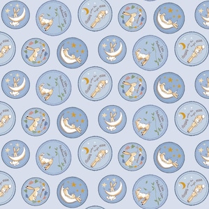 May include: A blue and white fabric with a repeating pattern of a bunny rabbit sleeping under a crescent moon. The pattern includes the text "Sleeping under the bright moon" and "Little Nutbrown Hare".
