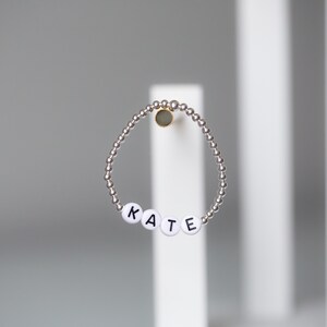 Black letters on white beads WITHOUT 4mm metallics between ELASTIC