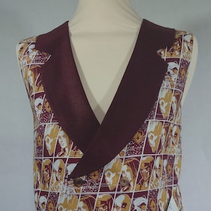 May include: A burgundy waistcoat with a double-breasted closure and a patterned front. The pattern features a comic book style design of characters from the Guardians of the Galaxy.