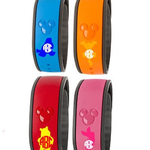 May include: Four colorful Disney MagicBands with Mickey Mouse ears and different character silhouettes. The bands are blue, orange, red, and pink with the letters "ABC" in white.