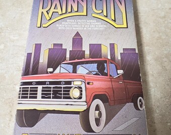 La ville pluvieuse Signé par Earl Emerson. 1985 Broché Avon Books. Livraison GRATUITE par la poste aux États-Unis. ChuckLivres