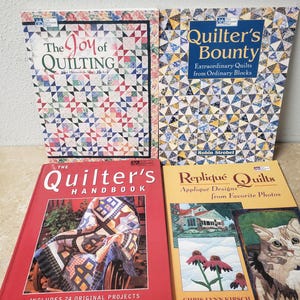 May include: Four quilting books with colorful covers. The titles are "The Joy of Quilting", "Quilter's Bounty", "The Quilter's Handbook", and "Repliqué Quilts".