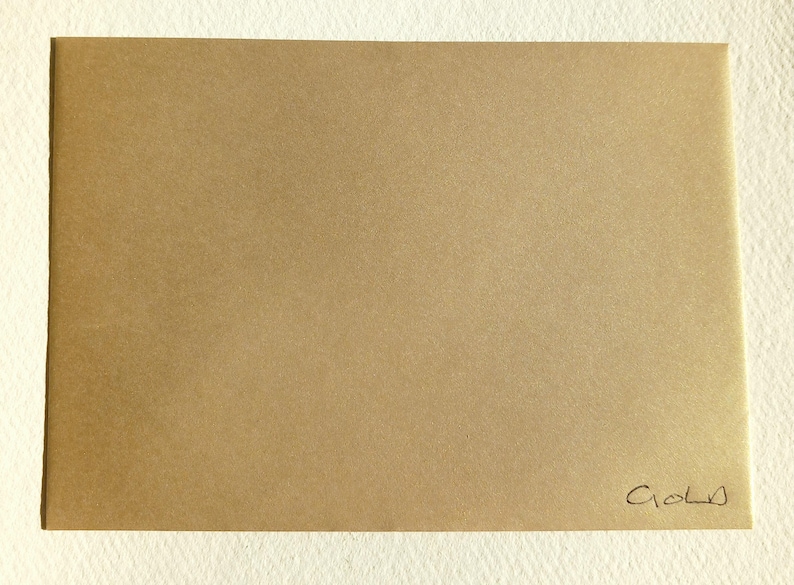May include: A gold envelope with the word "Gold" written in cursive on the bottom right corner.