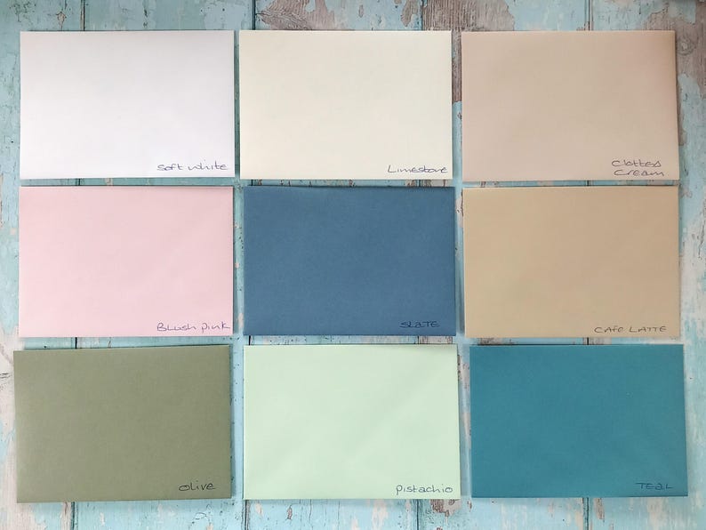 May include: Nine color swatches of cardstock paper in various shades of white, pink, blue, green, and brown. The swatches are labeled with the following names: Soft White, Limestone,  Clotted Cream, Blush Pink, Slate, Cafe Latte, Olive, Pistachio, and Teal.