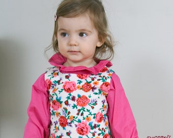 Baby blouse in plain pink cotton with flounce band on neckline