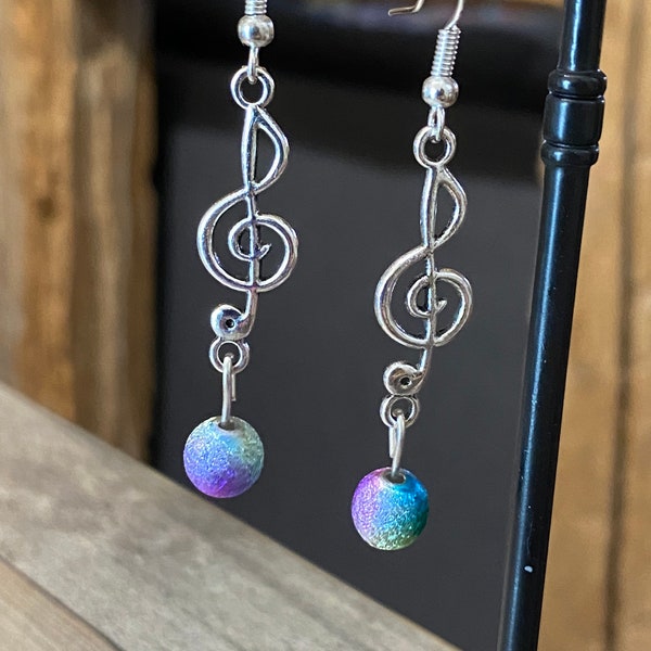 Silver metal earrings treble clef musical note and multicolored magic pearls