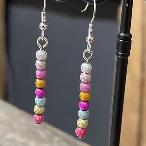 Silver metal dangling earrings with rainbow beads
