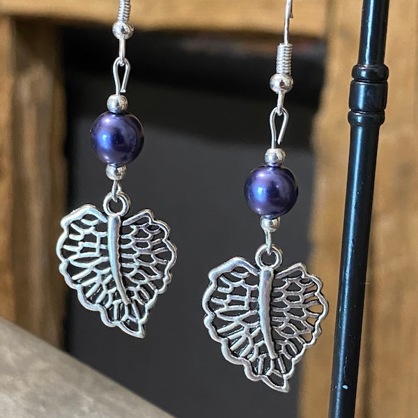 Boucles d’oreilles pendante en métal argenté feuille ajourée et perle mauve foncé