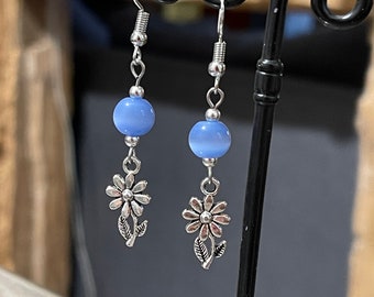 Silver metal dangling earrings with daisy flower and blue cat's eye pearl