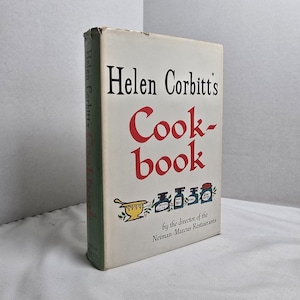 May include: A vintage cookbook titled "Helen Corbitt's Cook-book" with a white cover and red lettering. The book features illustrations of kitchenware and jars. The spine is green with the author's name.