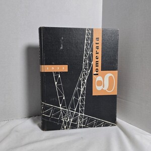 May include: A vintage hardcover book with a black cover featuring a white geometric design and the year "1955." The spine has the word "lomerata" in orange. The book's cover also has an orange design.