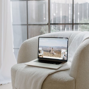 May include: A laptop computer with a white background open to a website with the text "Your love story, one moment at a time" and images of a couple in a desert landscape.