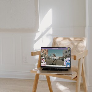 May include: A laptop computer on a wooden chair with a website open on the screen. The website has a light purple background with the text "Your life, your style, your story" in white. The website also features images of people skateboarding and other activities.