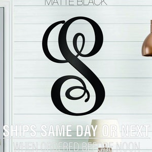 May include: Matte black metal monogram letter S with a decorative script font. The letter is mounted on a white wall.  SHIPS SAME DAY OR NEXT WHEN ORDERED BEFORE NOON.