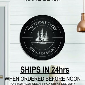 May include: Matte black metal sign with the text "PARTRIDGE CREEK WOOD DESIGNS" in a circle with a design of three pine trees and a duck in the center.