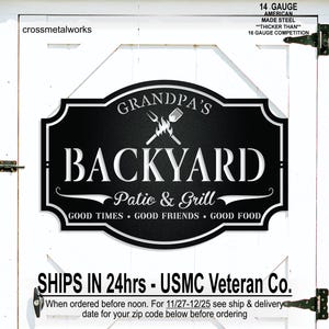 May include: A black metal sign with white text reading GRANDPA'S BACKYARD, Patio & Grill, and GOOD TIMES • GOOD FRIENDS • GOOD FOOD. The sign features a graphic of a flame with a fork and spatula. It is made of 14 gauge American made steel.