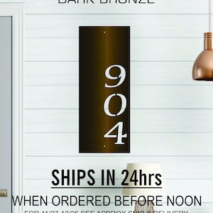 May include: Dark bronze metal house number plaque with the numbers 904 cut out in white. The plaque is mounted on a white wall. The text "SHIPS IN 24hrs WHEN ORDERED BEFORE NOON FOR 11/27-12/25 SEE APPROX SHIP & DELIVERY DATE FOR YOUR ZIP CODE BELOW BEFORE ORDERING" is printed below the plaque.