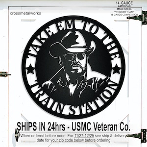 May include: Black metal wall art featuring a cowboy in a hat and sunglasses, with the text "TAKE 'EM TO THE TRAIN STATION." The art is made of 14-gauge American-made steel.