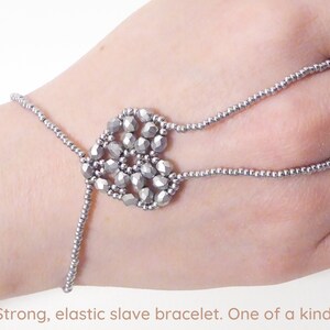 Silver metallic faceted heart. Elastic slave bracelet. Silver metallic seed bead. Ring bracelet. Hand jewelry. Hand finger jewelry. image 1