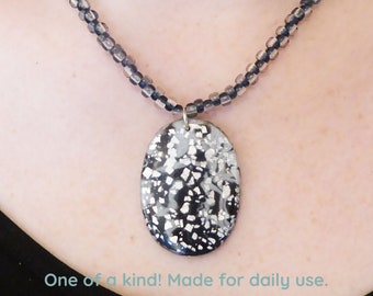 Silver & black Polymer clay pendant necklace. Silver foil flakes. Silver colored clasp and chain. Free form beaded seed beads necklace.