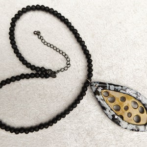 Gold polymer clay net, a frame of black and sparkling silver polymer clay. Black irregular glass beads. Black colored clasp and chain. image 6