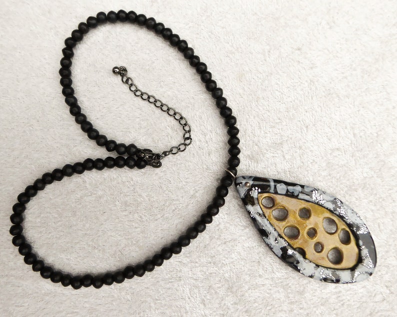 Gold polymer clay net, a frame of black and sparkling silver polymer clay. Black irregular glass beads. Black colored clasp and chain. image 6