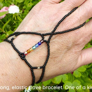 Rainbow / Chakra colored beads. Black elastic slave bracelet. Bracelet ring. Hand jewellery. Finger bracelet. Ring bracelet. Hand chain ring
