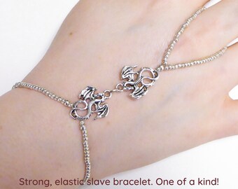 Two nickel free silver plated dragons. Silver metallic elastic slave bracelet. Finger bracelet. Hand jewelry. Ring bracelet. Hand bracelet.