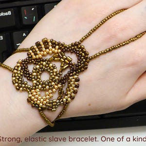 Freeform gold and bronze. Elastic slave bracelet. Beaded Bracelet ring. Hand jewellery. Finger bracelet. Ring bracelet. Hand chain ring.