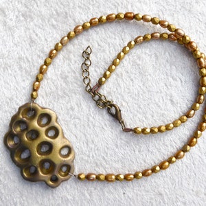 Gold polymer clay in a 3D net. Beautiful gold colored freshwater pearls. Faceted gold colored glass beads. Bronze colored clasp and chain. image 2