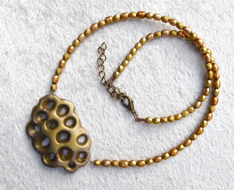 Gold polymer clay in a 3D net. Beautiful gold colored freshwater pearls. Faceted gold colored glass beads. Bronze colored clasp and chain. image 2