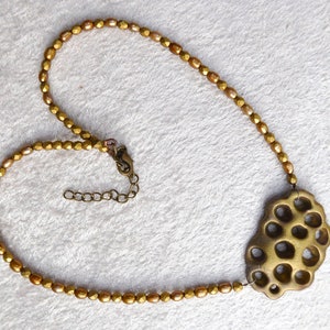 Gold polymer clay in a 3D net. Beautiful gold colored freshwater pearls. Faceted gold colored glass beads. Bronze colored clasp and chain. image 5