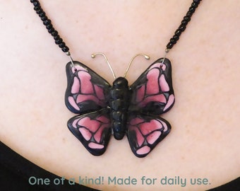 Butterfly in pink and black Polymer clay pendant necklace. Super soft matte finish. Silver plated clasp and chain. Free form necklace.